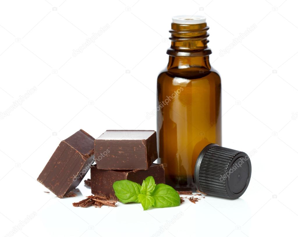 Essential oil essential and chocolate with mint leaves isolated